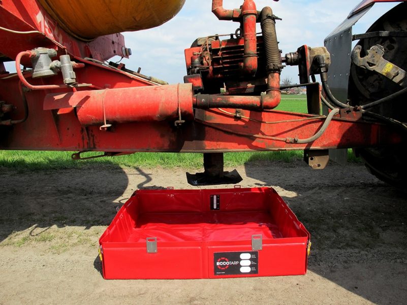 Oil drip tray under tractor for spill containment.