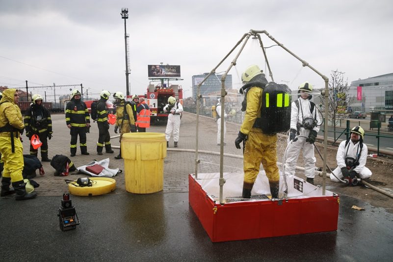 Firefighters practising decontamination procedures outdoors.