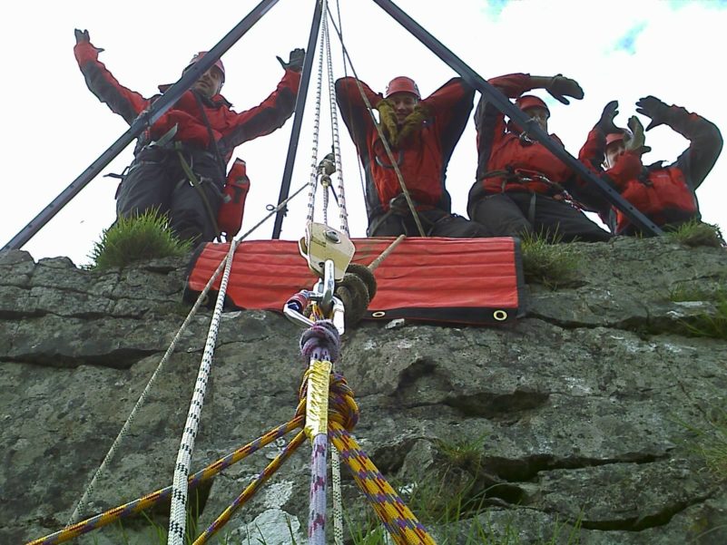 Rescue team setting up ropes for climbing.