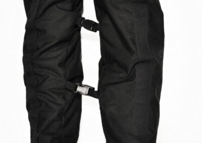 Black protective trousers and boots against a white background.
