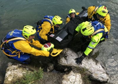 Rescue team retrieving a person from the water.