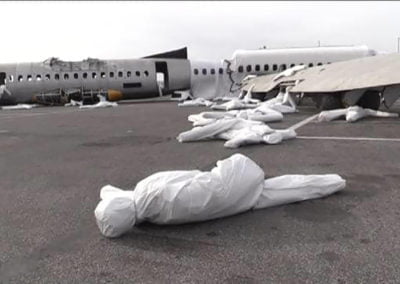 Airplane crash training site with wrapped dummies.