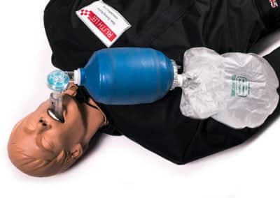 CPR training mannequin with resuscitation bag and mask.
