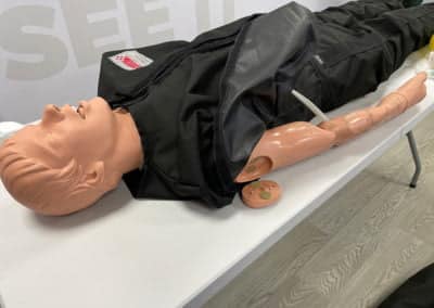 Medical training mannequin on a table for demonstration.