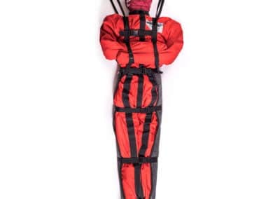Patient immobilisation device for emergency scenarios, red with black straps.