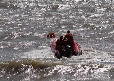 Rescue boat navigating through rough sea waves.