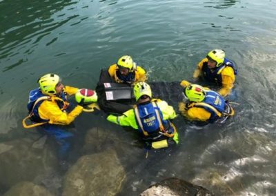 Rescue team practising water recovery skills.