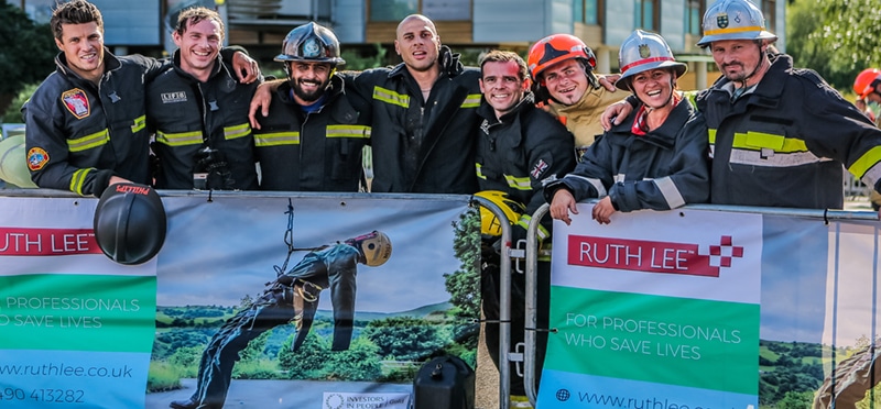 Firefighters standing together in front of Ruth Lee banner.