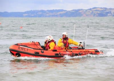 RNLI lifeboat crew navigating coastal waters.
