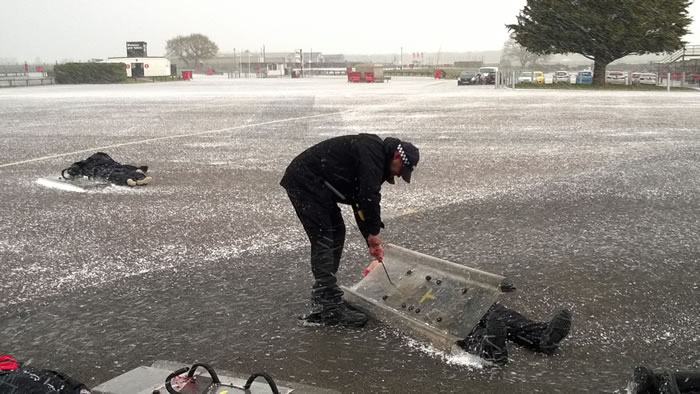 Police officer training in heavy rain and strong winds.