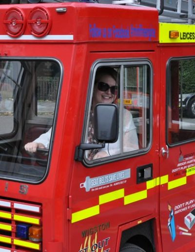 Woman driving Leicestershire Fire and Rescue Service mini fire engine.