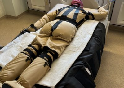 Medical practice mannequin in hospital bed.