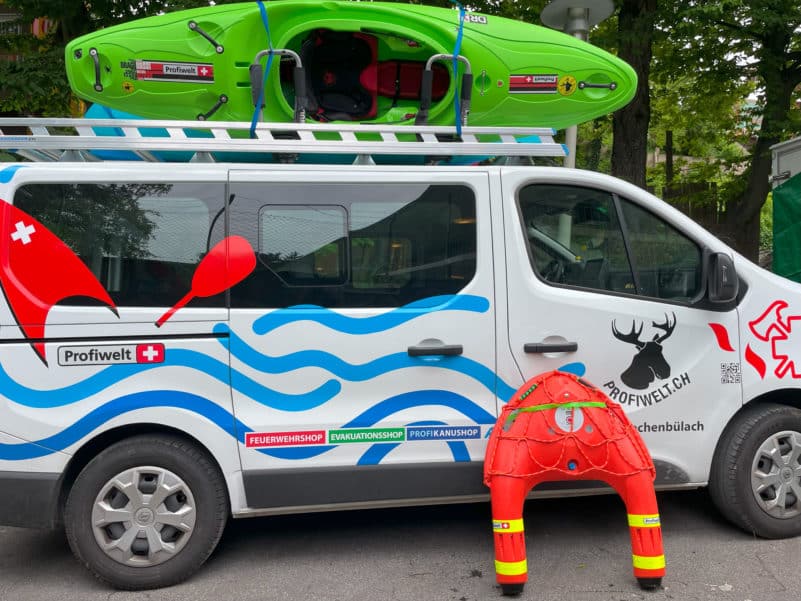 Van with kayak and lifeguard equipment.