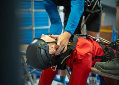 Rescue training on mannequin with safety gear.