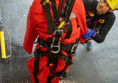 Rescue training with mannequin and safety harness.