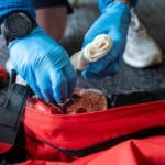 Paramedic tending to a leg wound