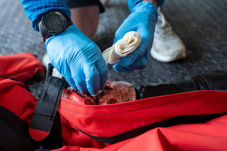 Paramedic tending to a leg wound